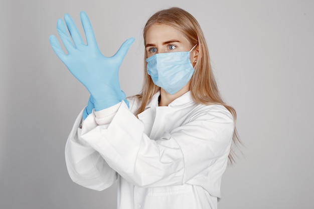 Free photo doctor in a medical mask. coronavirus theme. isolated over white wall