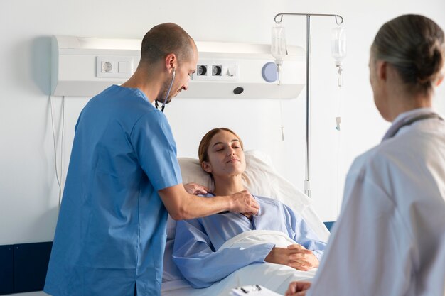 Doctor and nurse helping patient close up