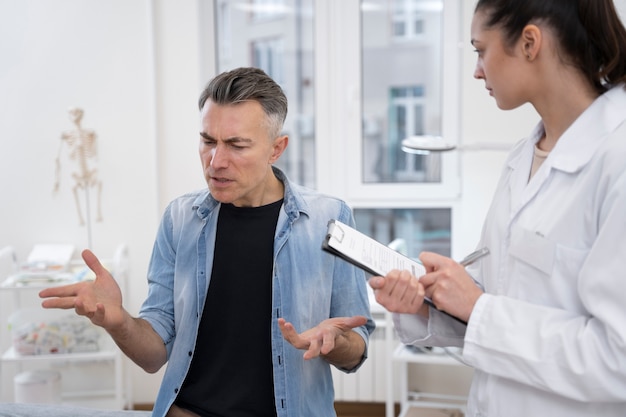 Free photo doctor performing routine medical checkup