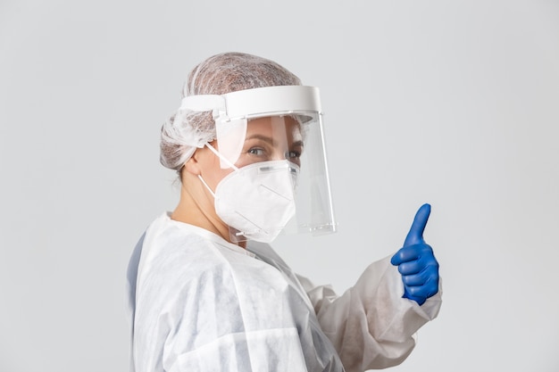 Doctor in personal protective equipment posing