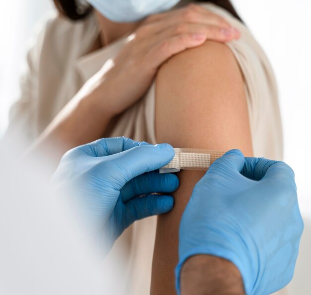 Doctor putting a bandage on a patient's arm close-up