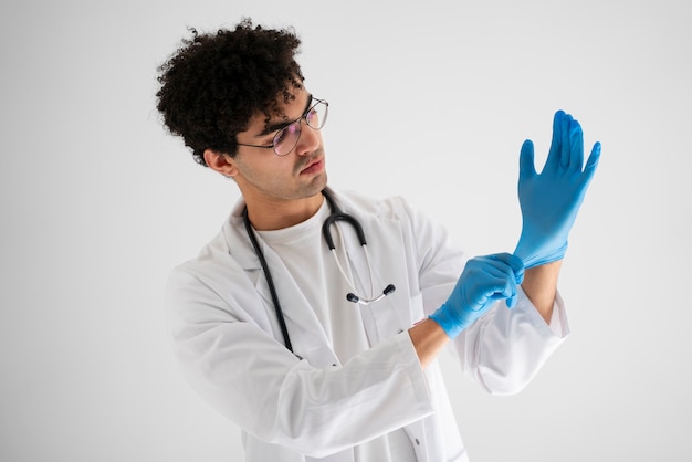 Doctor putting on gloves medium shot