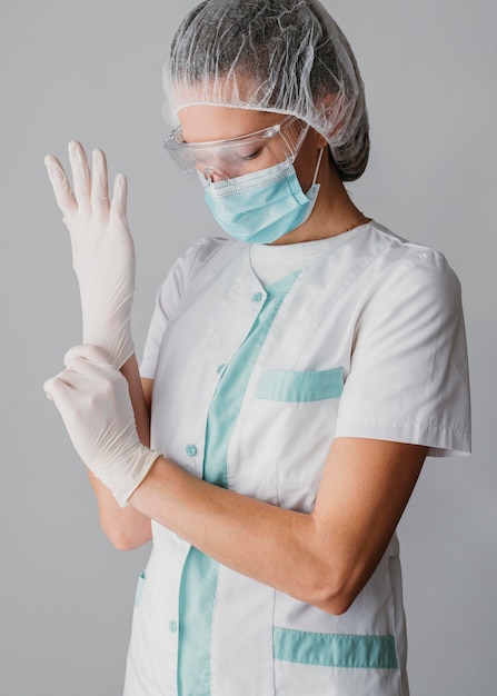 Doctor putting on surgical gloves