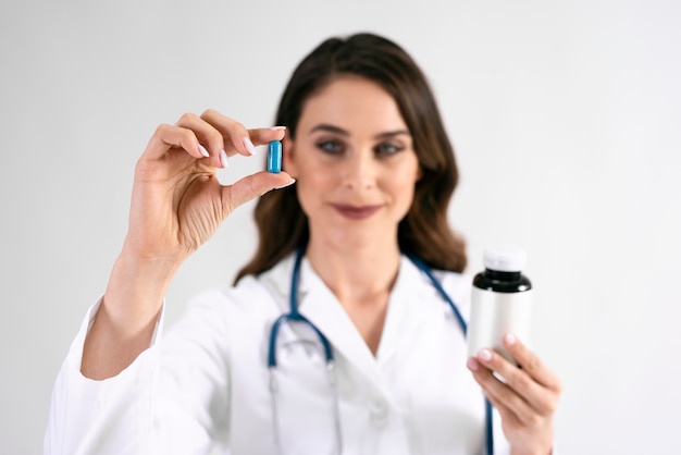 Doctor's hand holding pill