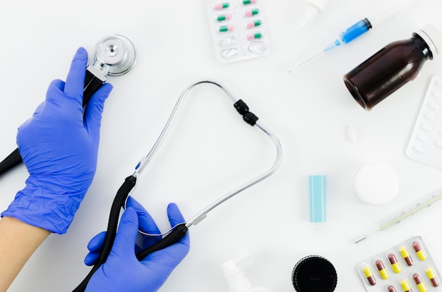 Doctor's hand with stethoscope and medical equipment's on white background