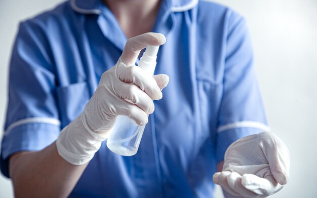 Doctor uses an antiseptic with white gloves against of the Corona covid-19 virus.