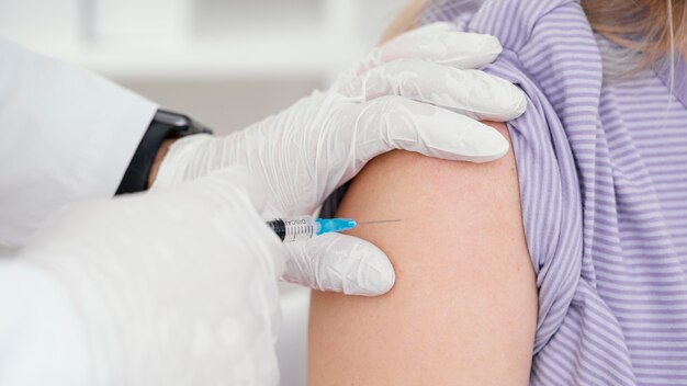 Doctor vaccinating a patient in the clinic