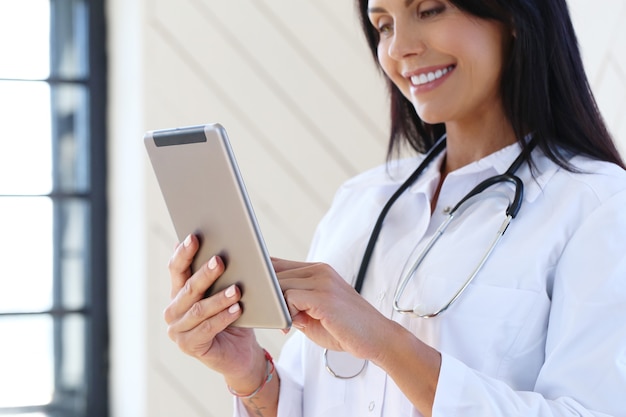 Free Photo doctor wearing white robe and stethoscope