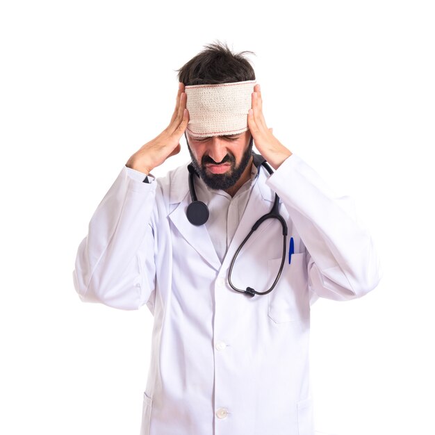 Doctor with headache over white background