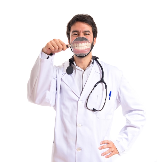 Doctor with magnifying glass over white background