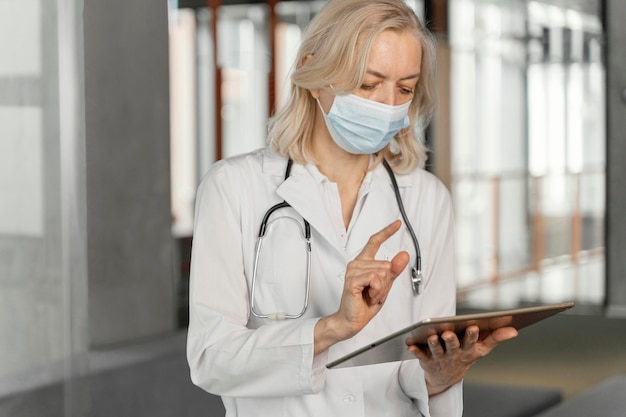 Free Photo doctor with medical mask checking her notes