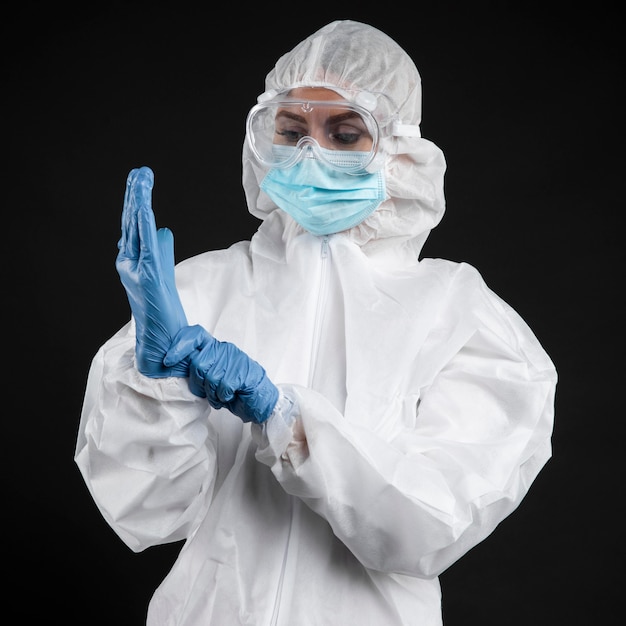 Doctor with putting on surgical gloves