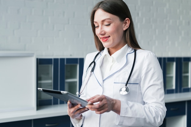 Free Photo doctor with a stethoscope and a tablet