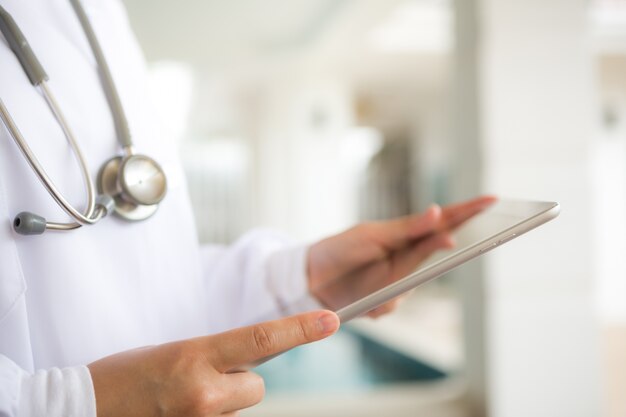 Doctor with tablet in hands