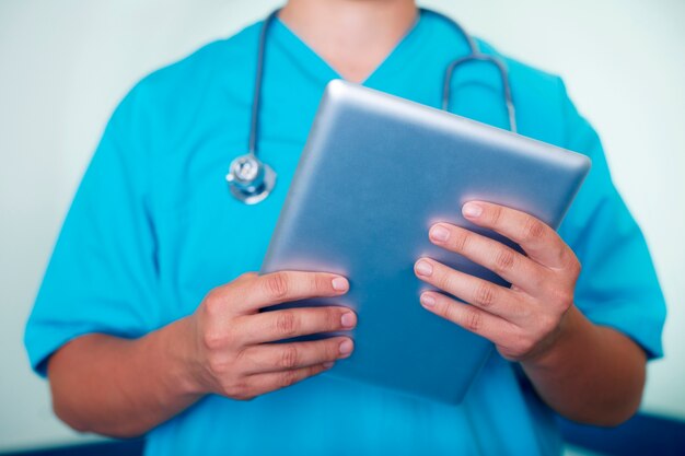 Doctor working on digital tablet