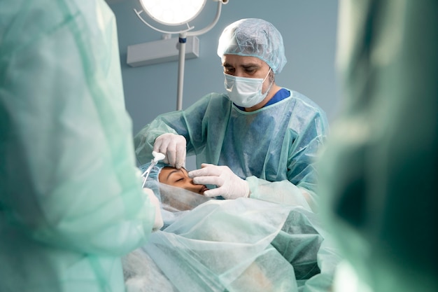 Doctors in operating room performing rhinoplasty