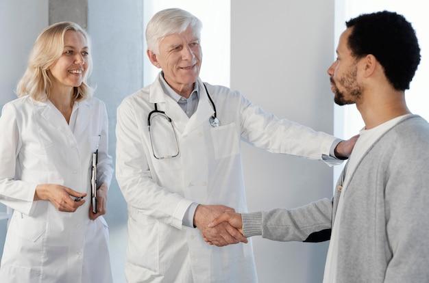 Free photo doctors talking with a young patient