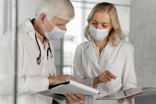 Doctors with medical masks talking