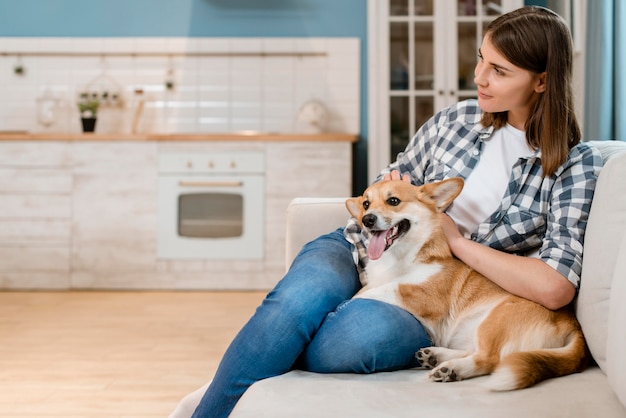 Dog and owner at home on the couch