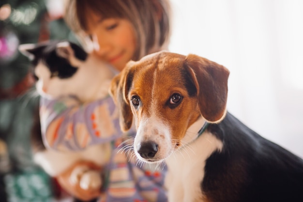 The dog sitting near girl