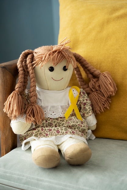 Doll wearing yellow ribbon