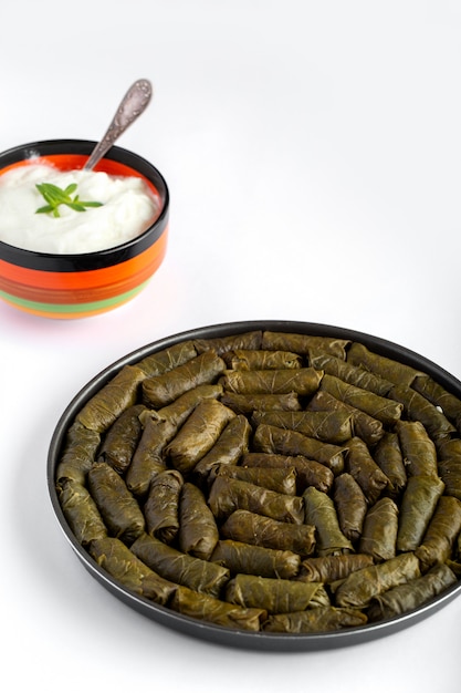 Dolma dolma in round pan and yoghurt