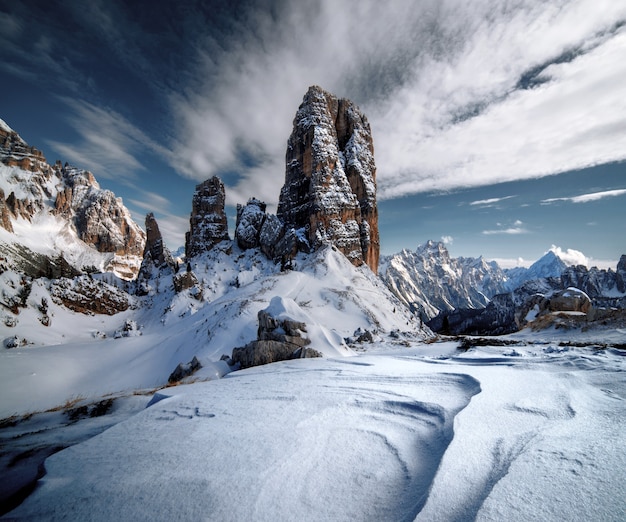 Dolomites covered in the snow under the sunlight and a cloudy sky in Italian Alps in winter