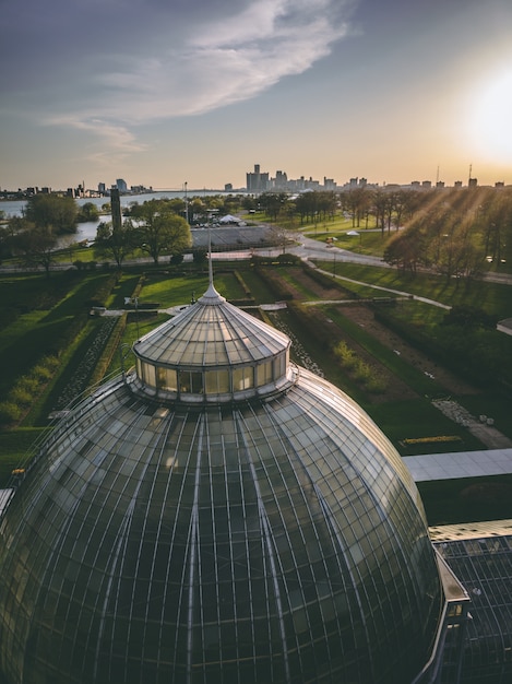 Dome in a park surrounded by greenery with buildings under sunlight during sunset