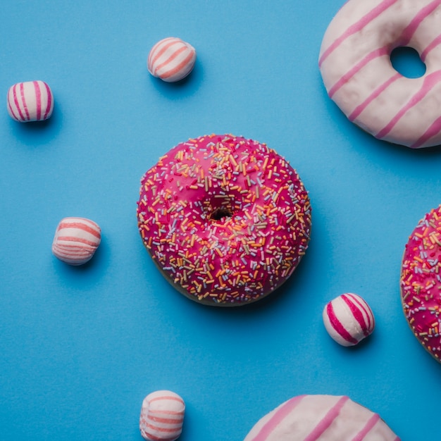 Free photo donuts and sugar balls on blue texture