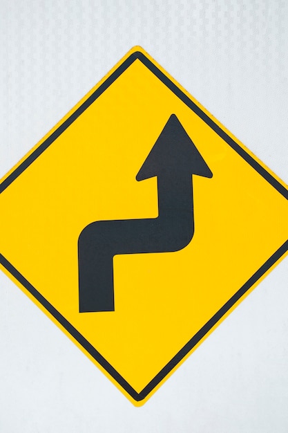 Free photo double bend road arrow sign close-up