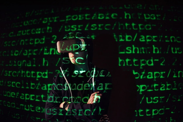 Free photo double exposure of a caucasian man and virtual reality vr headset is presumably a gamer or a hacker cracking the code into a secure network or server, with lines of code in green