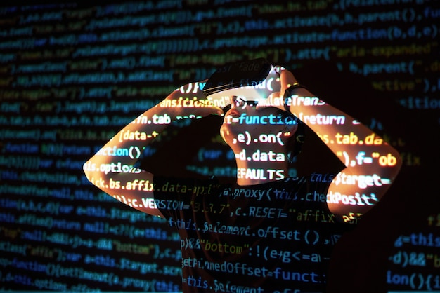 Free photo double exposure of a caucasian man and virtual reality vr headset is presumably a gamer or a hacker cracking the code into a secure network or server, with lines of code