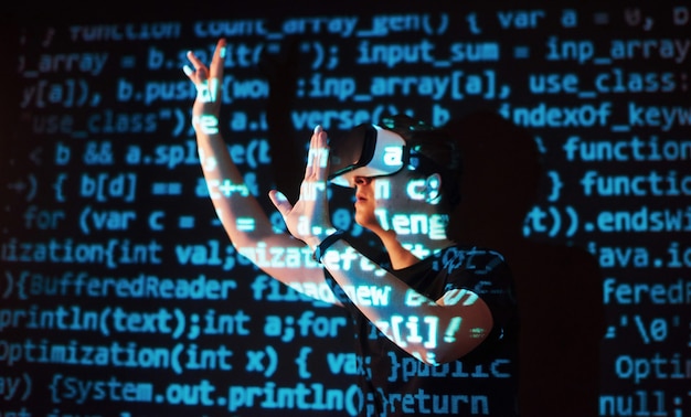 Free Photo double exposure of a caucasian man and virtual reality vr headset is presumably a gamer or a hacker cracking the code into a secure network or server, with lines of code