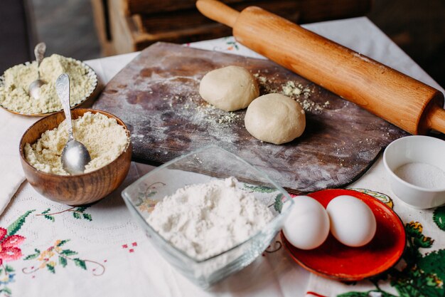 dough meat meal pastry in process of making dough cook flour eggs on brown wood rustic desk