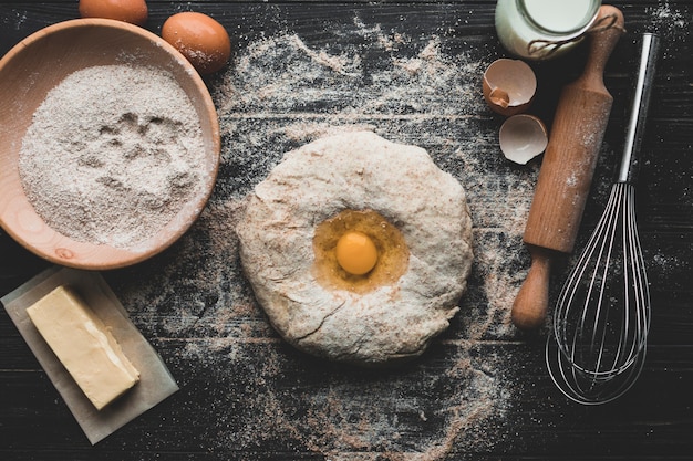 Dough with beaten egg on table