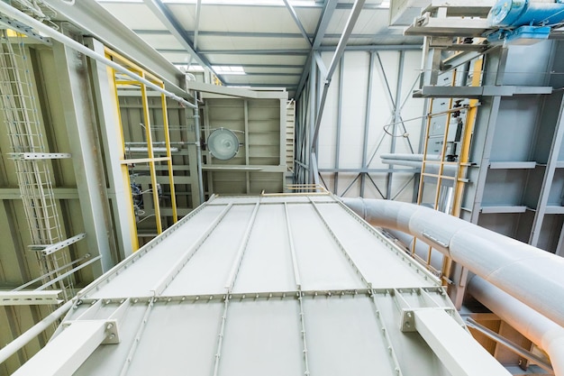 Free Photo down up view of modern operational plant with grey pipes and ladders heavy industry machinery metalworking workshop concept