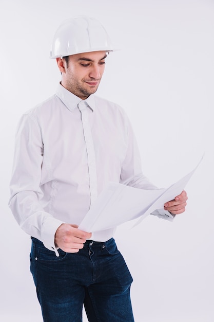 Free photo draftsman examining blueprint