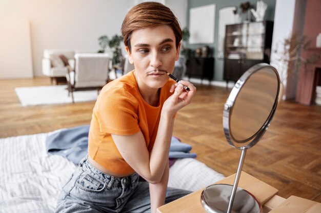 Drag king putting on makeup medium shot