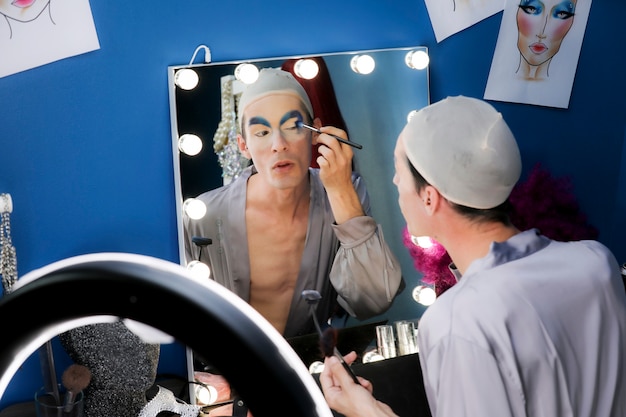 Drag person putting on makeup