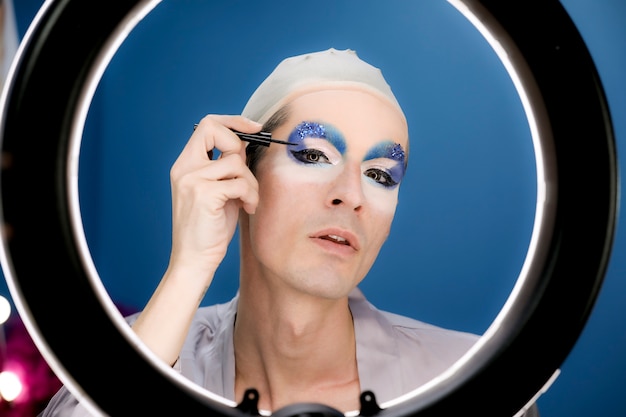 Drag person putting on makeup