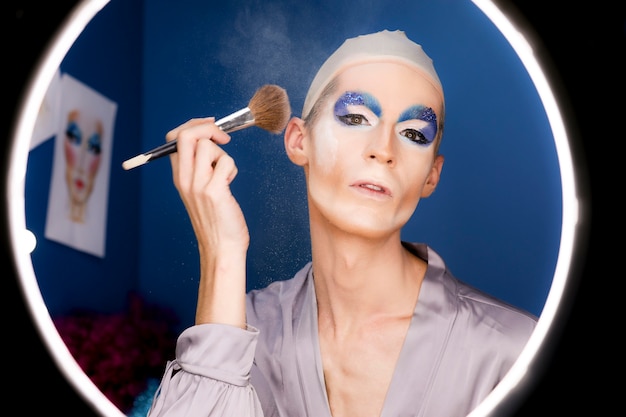 Free Photo drag person putting on makeup