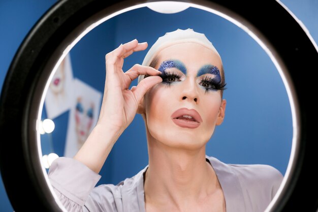 Drag person putting on makeup