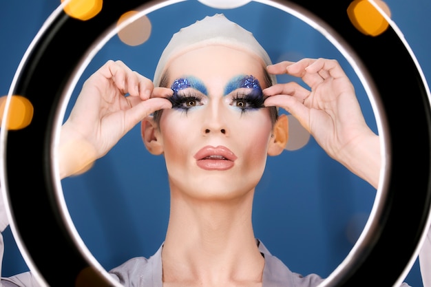 Free Photo drag person putting on makeup