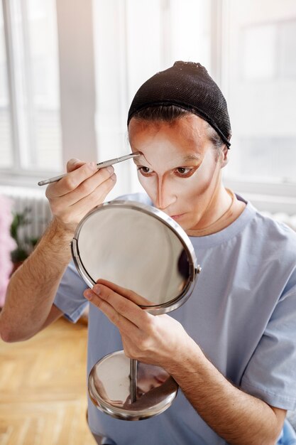 Drag queen putting makeup on high angle