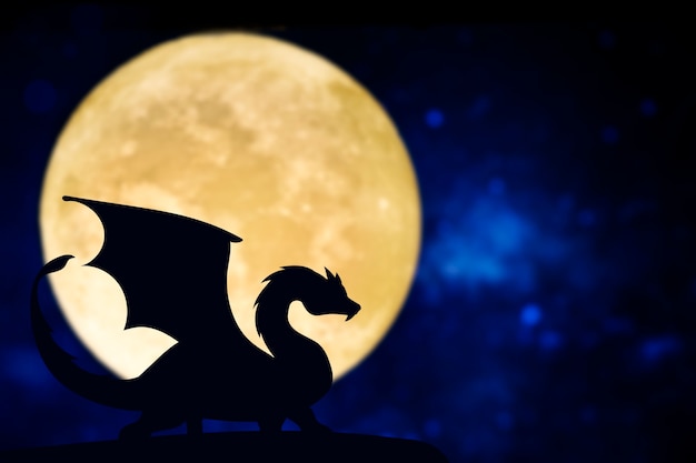 Free Photo dragon silhouette over a full moon