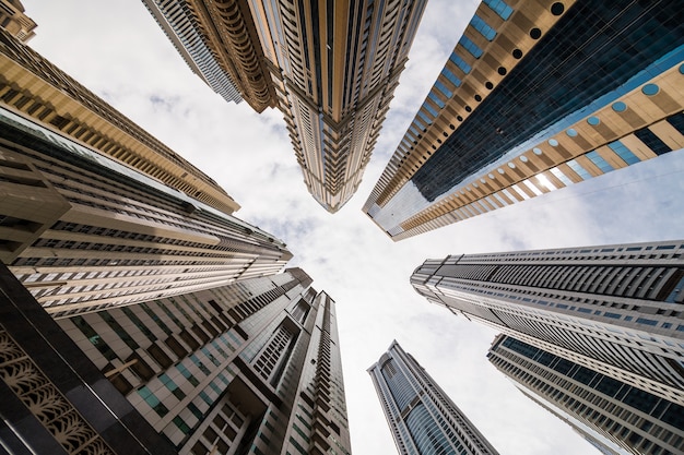 Free Photo dramatic perspective with low angle view of skyscrapers looking up to the sky, dubai. vanishing point