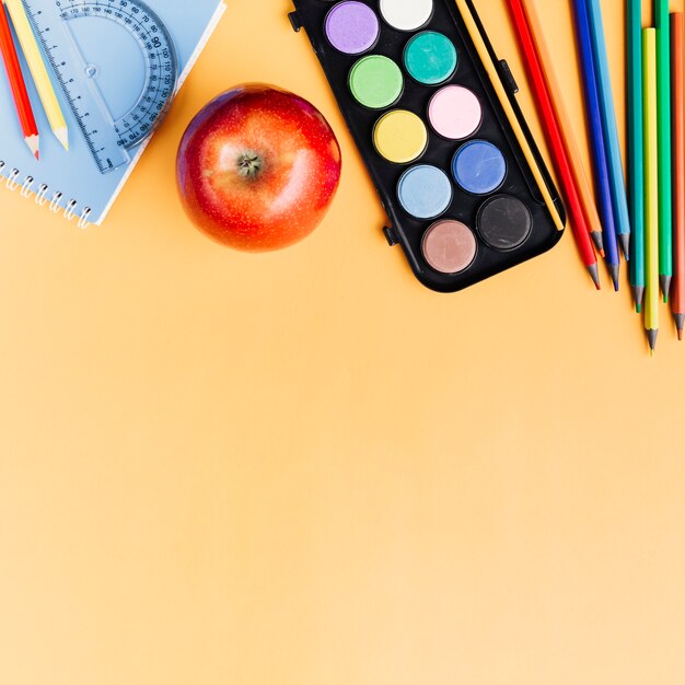 Free photo drawing tools scattered on yellow desk