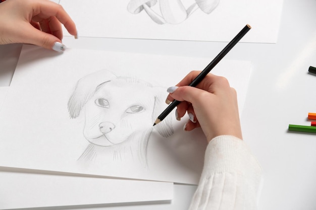 Free photo drawing a young girl hand drawing a cute dog with the black pencil