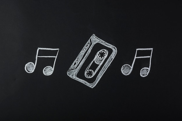 Free Photo drawn musical notes with cassette tape on blackboard