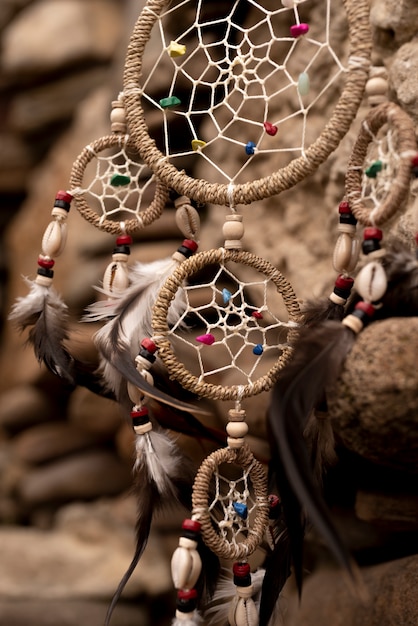 Free photo dreamcatcher hanging from a rock